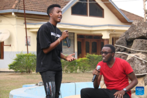 Pacifique Izabayo (L) and his team member sing a Chinese song together for sharing a short video on Douyin in Kigali, Rwanda, on Aug. 13, 2022. Rwandan youth, Pacifique Izabayo, has become a hit on Douyin, the Chinese version of TikTok, for singing Chinese songs while showing Rwandan rural life. (Photo by Huang Wanqing/Xinhua)